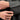 Person adjusting the sleeve of a gray thobe with a close-up on the hand and cuff.
